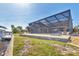 Expansive backyard with a screened lanai, outdoor seating, and picturesque waterfront views, perfect for entertaining at 2418 Herron Ter, Port Charlotte, FL 33981