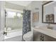 Contemporary bathroom with tub and shower combo, updated fixtures, and decorative seashell art at 2418 Herron Ter, Port Charlotte, FL 33981