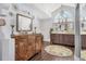 Elegant bathroom featuring double vanity, chandelier, and decorative wall accents at 2418 Herron Ter, Port Charlotte, FL 33981