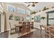 Bright dining room boasts high ceilings, dark wood floors, and sliding barn door access at 2418 Herron Ter, Port Charlotte, FL 33981