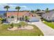 Charming single-story home features well-manicured lawn, landscaping, and a wide driveway at 2418 Herron Ter, Port Charlotte, FL 33981