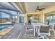 Charming lanai with a dining table, providing a relaxing space to enjoy meals while overlooking the pool and outdoor area at 2418 Herron Ter, Port Charlotte, FL 33981