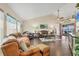 Inviting living room with vaulted ceilings, comfortable seating, and direct access to outdoor living at 2418 Herron Ter, Port Charlotte, FL 33981