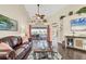 Bright living room featuring vaulted ceilings, a ceiling fan, and backyard access at 2418 Herron Ter, Port Charlotte, FL 33981