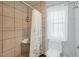 Tiled shower with built-in bench and clear glass window in updated bathroom at 2418 Herron Ter, Port Charlotte, FL 33981