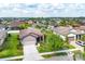 Aerial view of a well-maintained single-Gathering home with a two-car garage and lush landscaping in a suburban neighborhood at 2572 Sherman Oak Dr, North Port, FL 34289