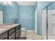 The bathroom has double sinks, dark cabinets, and walk-in shower at 2572 Sherman Oak Dr, North Port, FL 34289