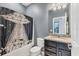 Bathroom features a shower with an extraterrestrial themed shower curtain, granite countertop and basin sink at 2572 Sherman Oak Dr, North Port, FL 34289
