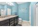 This primary bathroom features a walk-in shower, double sinks and vanity with granite countertop at 2572 Sherman Oak Dr, North Port, FL 34289