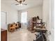 Cozy bedroom featuring tiled floors, ceiling fan and light, with a variety of furniture and decor at 2572 Sherman Oak Dr, North Port, FL 34289
