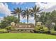 Stunning community entrance with beautiful stone and lush landscaping at Cedar Grove at 2572 Sherman Oak Dr, North Port, FL 34289