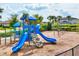 Vibrant community playground featuring a slide, climbing wall, and swings at 2572 Sherman Oak Dr, North Port, FL 34289
