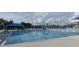 Long community pool for swimming laps with blue pool covers and lounge seating at 2572 Sherman Oak Dr, North Port, FL 34289