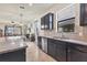 Spacious kitchen with dark cabinetry, granite counters, and an adjacent living area at 2572 Sherman Oak Dr, North Port, FL 34289
