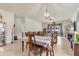 This spacious living room has tile floors, a ceiling fan and opens up to the kitchen and dining area at 2572 Sherman Oak Dr, North Port, FL 34289
