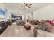 Open-concept living room featuring tile floors and seamless flow into the kitchen at 2572 Sherman Oak Dr, North Port, FL 34289