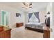 This main bedroom features tile floors, a ceiling fan and an ensuite bathroom at 2572 Sherman Oak Dr, North Port, FL 34289