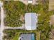 Aerial view of the home, with an overview of the backyard space and surrounding mature landscaping at 2760 Lemon Ave, Englewood, FL 34223