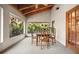 Bright dining area featuring wood ceiling, a square table, four chairs, and large windows offering lush greenery views at 2760 Lemon Ave, Englewood, FL 34223
