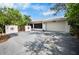 Exterior features a spacious driveway, garage, and decorative fence at 2760 Lemon Ave, Englewood, FL 34223