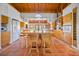 Spacious kitchen with an island, terracotta tile floors, and natural wood cabinets, perfect for entertaining at 2760 Lemon Ave, Englewood, FL 34223