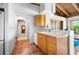Bright kitchen area with terracotta tile flooring, natural wood cabinets, and a functional layout at 2760 Lemon Ave, Englewood, FL 34223