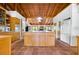 Expansive kitchen featuring terracotta tile flooring, natural wood cabinets, and modern appliances at 2760 Lemon Ave, Englewood, FL 34223