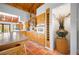 Bright kitchen with terracotta flooring, vaulted ceilings, and natural wood cabinets for storage at 2760 Lemon Ave, Englewood, FL 34223