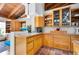 Well-appointed kitchen featuring natural wood cabinets, terracotta flooring, and vaulted wood ceilings at 2760 Lemon Ave, Englewood, FL 34223