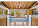 Inviting living room with vaulted ceilings, wood beams, and natural light flooding through large windows and doors at 2760 Lemon Ave, Englewood, FL 34223