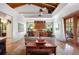 Cozy living room featuring wood floors, a ceiling fan, and a large window with a view of the outdoors at 2760 Lemon Ave, Englewood, FL 34223