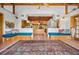 Open living space with vaulted ceilings, custom built-in benches, and a large area rug at 2760 Lemon Ave, Englewood, FL 34223