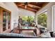 Bright screened porch with wood ceiling, wicker seating, a glass coffee table, and lush greenery views at 2760 Lemon Ave, Englewood, FL 34223