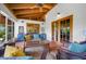 Bright screened porch with wood ceiling, wicker seating, a glass coffee table, and lush greenery views at 2760 Lemon Ave, Englewood, FL 34223
