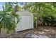 Outdoor storage shed surrounded by trees and landscaping at 2760 Lemon Ave, Englewood, FL 34223