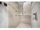 Modern shower with multiple shower heads, a built-in seat, and stylish tile work for a spa-like experience at 2760 Lemon Ave, Englewood, FL 34223