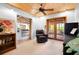 Sitting room featuring wood ceiling, carpet flooring, access to screened porch, and a bookcase at 2760 Lemon Ave, Englewood, FL 34223