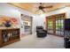 Sitting room featuring wood ceiling, carpet flooring, access to screened porch, and a bookcase at 2760 Lemon Ave, Englewood, FL 34223