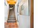 Staircase with carpet runner and wood railing, leading to the upper level of the home at 2760 Lemon Ave, Englewood, FL 34223