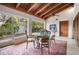 Bright sunroom with wood ceiling, seating, and large windows offering views of the backyard at 2760 Lemon Ave, Englewood, FL 34223