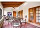 Cozy sunroom with wood ceiling, tiled floor, seating, and access to the outdoors at 2760 Lemon Ave, Englewood, FL 34223