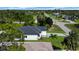 Aerial view of single-Gathering home surrounded by trees and greenery in a residential neighborhood at 280 Antis Dr, Rotonda West, FL 33947