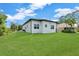 Lush backyard featuring verdant green lawn and contemporary architecture at 280 Antis Dr, Rotonda West, FL 33947