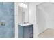 Bathroom with granite vanity and modern shower with blue tile at 280 Antis Dr, Rotonda West, FL 33947