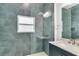 Modern bathroom featuring blue tiles, glass shower, and granite countertop vanity at 280 Antis Dr, Rotonda West, FL 33947