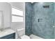 Bathroom featuring a walk-in shower, sleek tile, and a granite countertop at 280 Antis Dr, Rotonda West, FL 33947