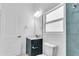 Bright bathroom with a modern vanity, granite countertop, and an illuminated mirror at 280 Antis Dr, Rotonda West, FL 33947