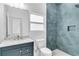 Stylish bathroom with a blue tiled shower, granite countertop, under-mount sink, and modern fixtures at 280 Antis Dr, Rotonda West, FL 33947
