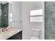 Bathroom featuring blue tiles in shower, toilet, and granite countertop vanity at 280 Antis Dr, Rotonda West, FL 33947