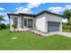 Attractive single-Gathering home with a well-kept lawn and inviting brick paver walkway leading to the entrance at 280 Antis Dr, Rotonda West, FL 33947